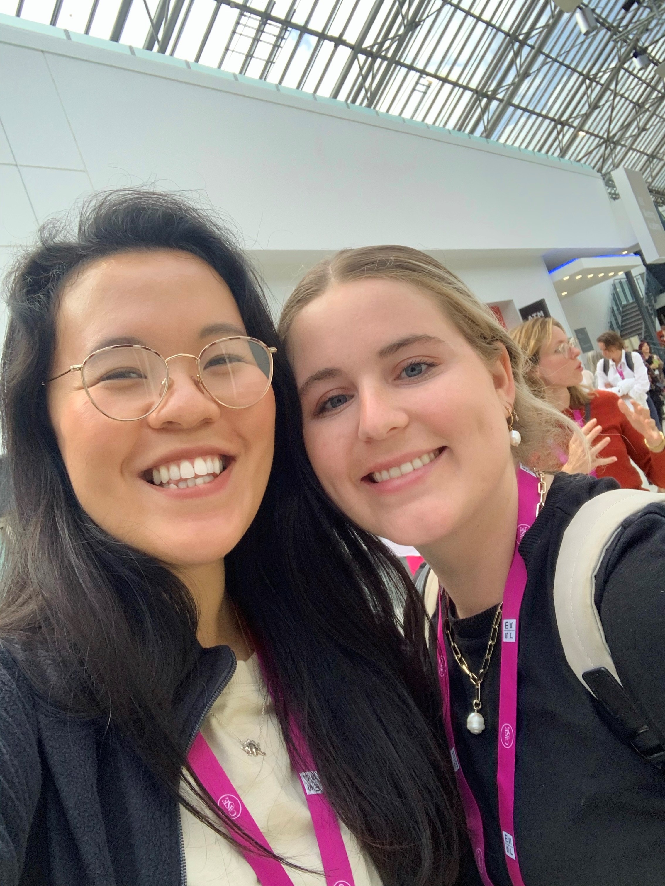 Selfie of Jackie Yip and another member of her graduate trainee cohort. They both wear pink CASE landyards.