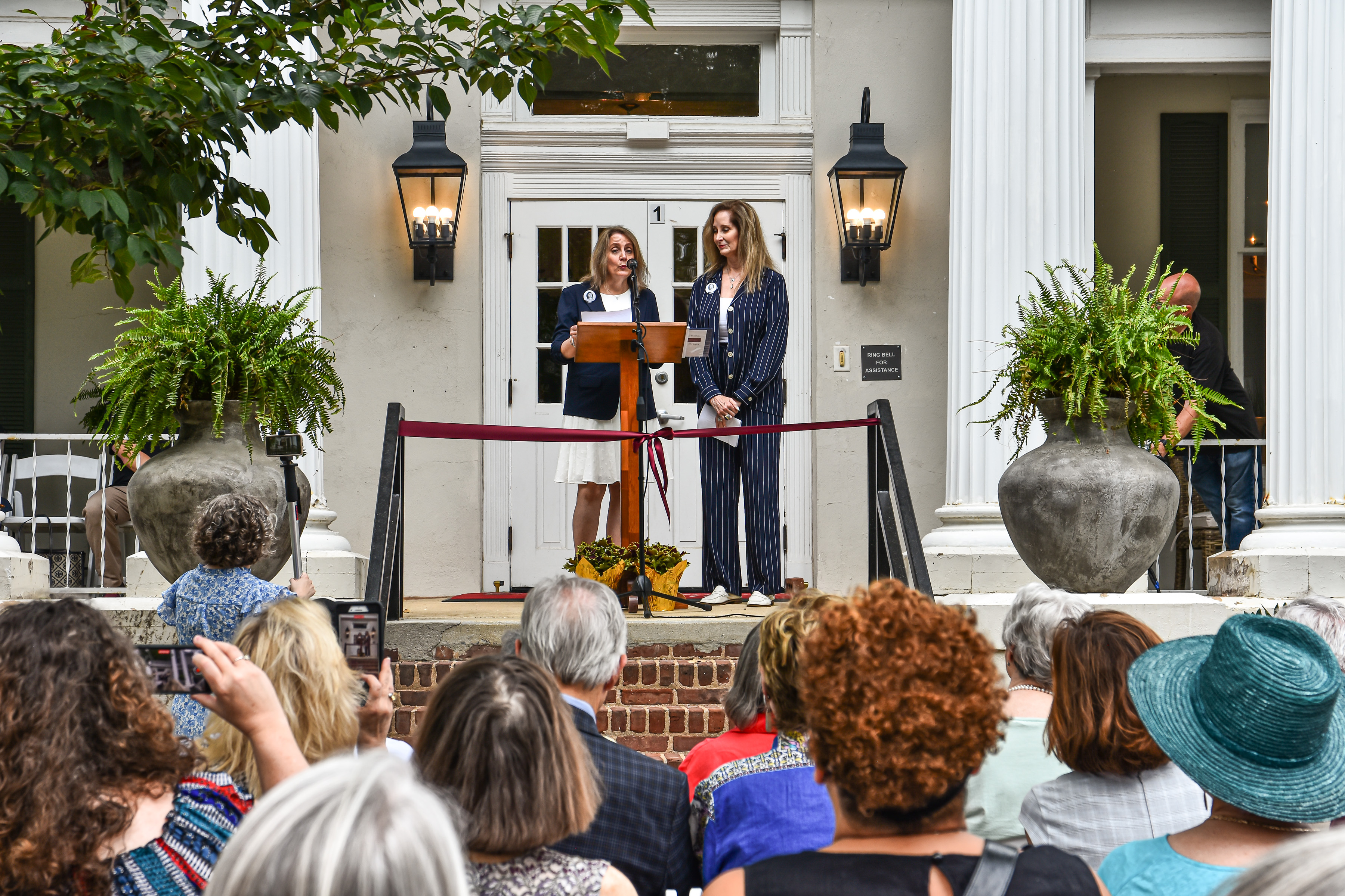 Karen and Kathryn Holcombe, twin daughters of Betty and Milton Holcombe, whose gift made the Morgan-Holcombe Alumni Center possible, spoke at the June 2024 dedication. 