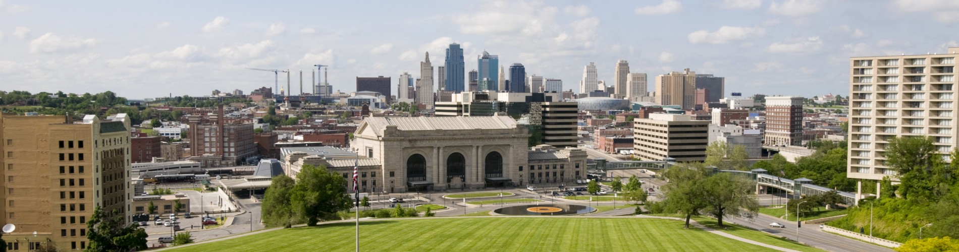 Wide-angle view of central Kansas City, with the Lincoln Memorial lawn, Union Station, and Crown Center in the foreground, and downtown Kansas City behind