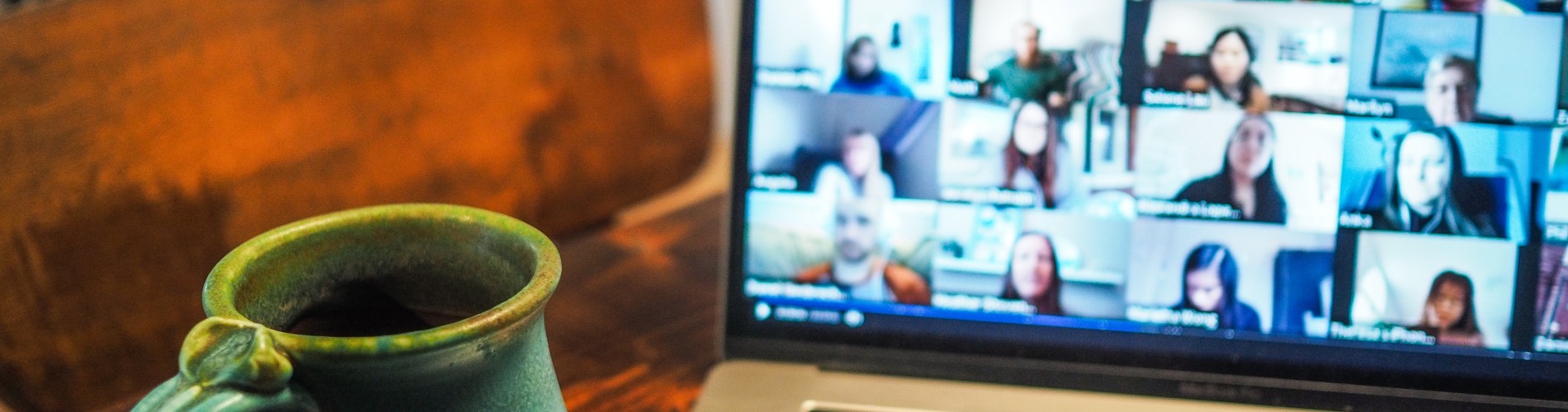 Mug on a desk in front of laptop during a video call