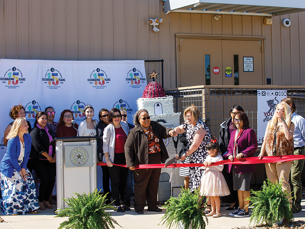 In front of the Educare childcare center, a ribbon cutting takes place.