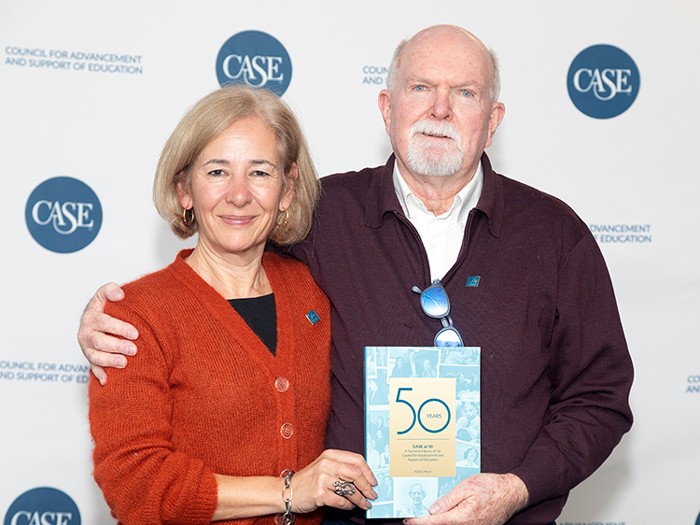 Rob Moore and Sue Cunningham holding a copy of the CASE at 50.