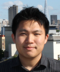 Headshot of Nathan Lam with city in background